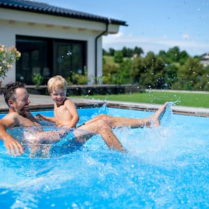 father and son playing in the pool